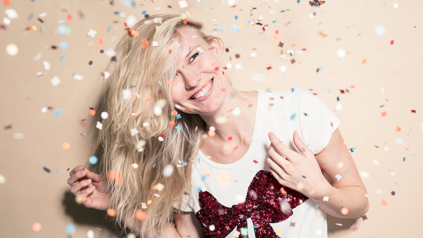 Woman with blonde hair covered in confetti