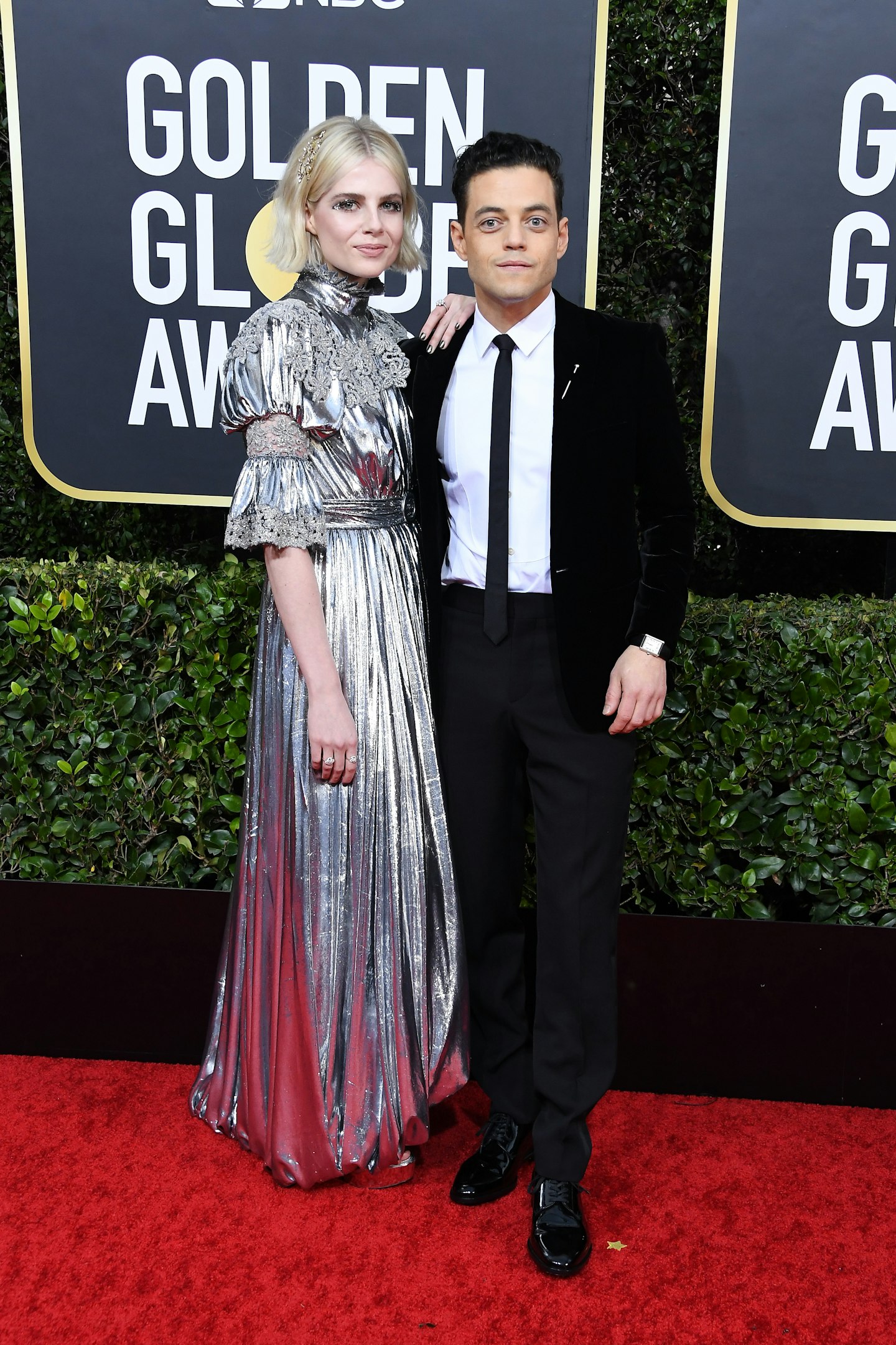 Lucy Boynton, wearing a custom Louis Vuitton gown and Rami Malek in Saint Laurent