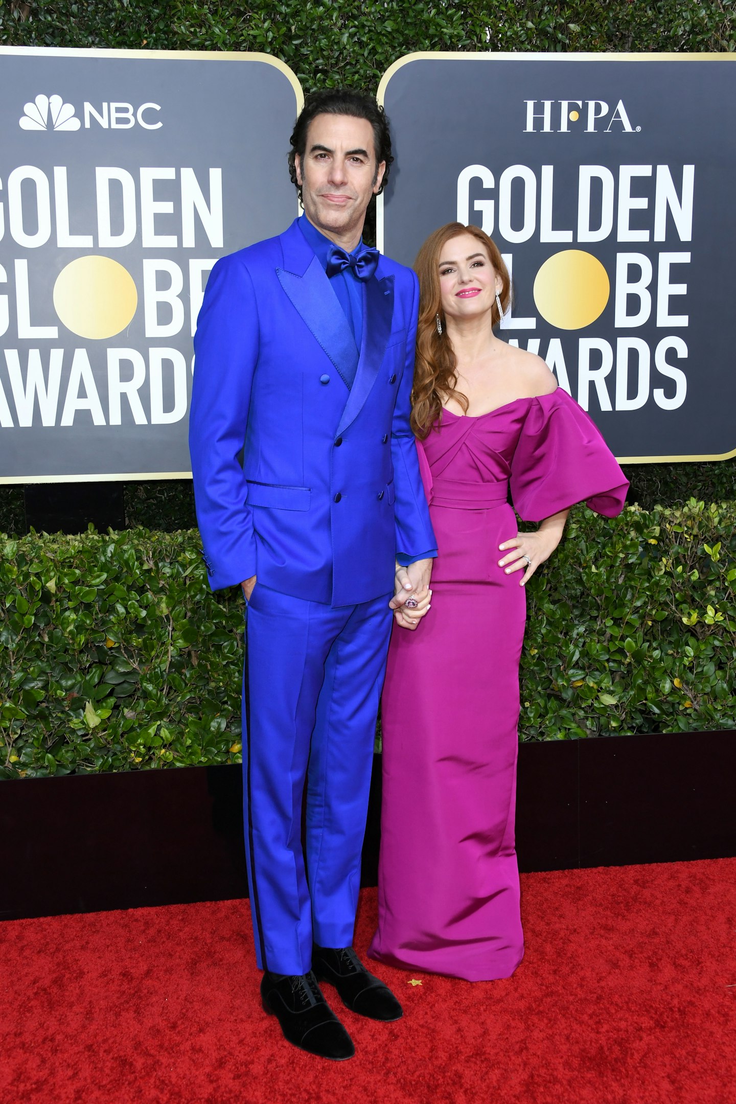Sacha Baron Cohen in an electric blue suit with Isla Fisher in Monique Lhuillier