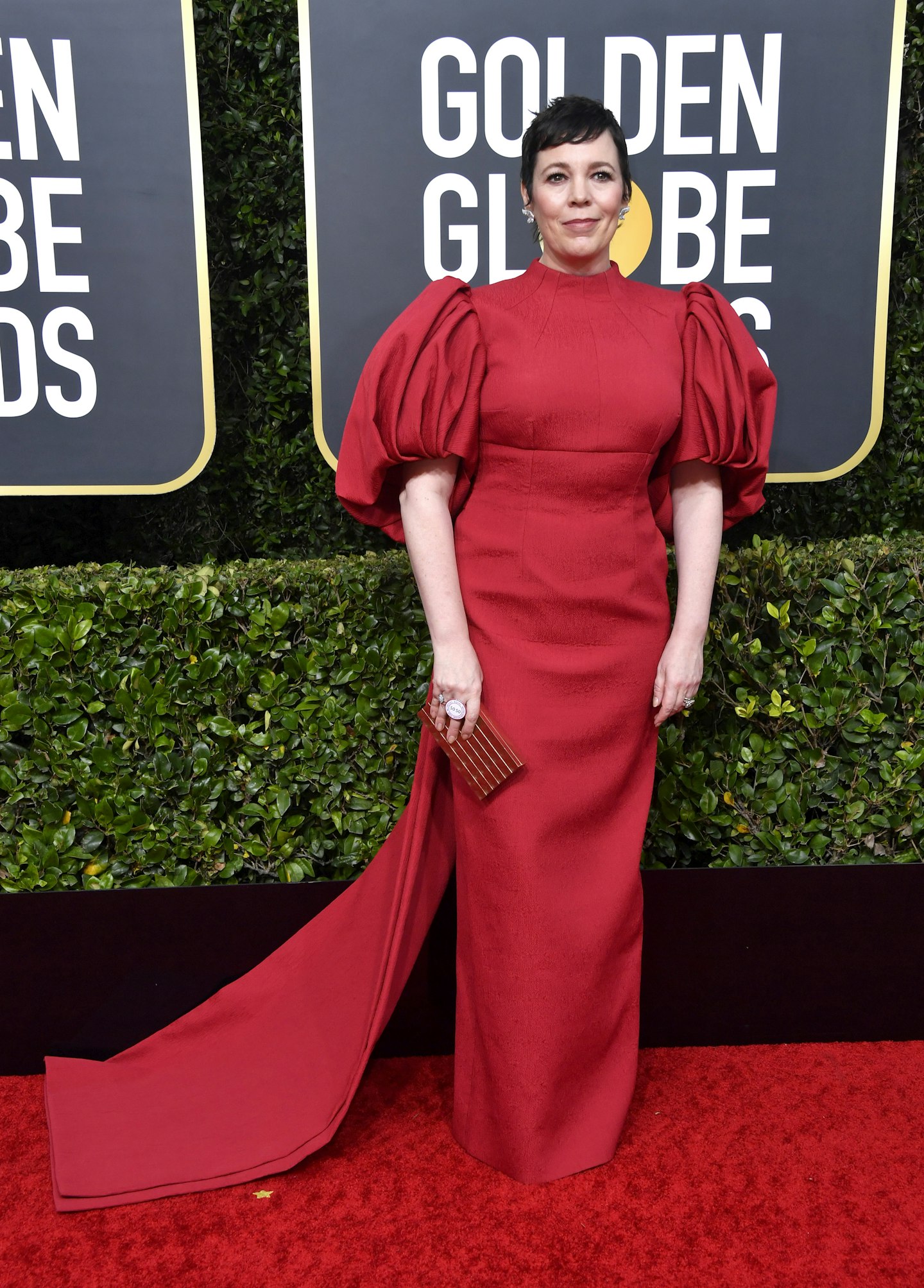 Olivia Colman wearing a red Emilia Wickstead gown with exaggerated puff sleeves