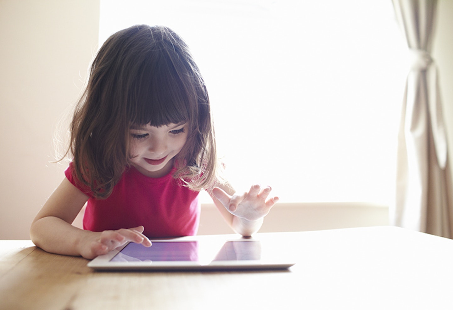 Young girl playing with tablet