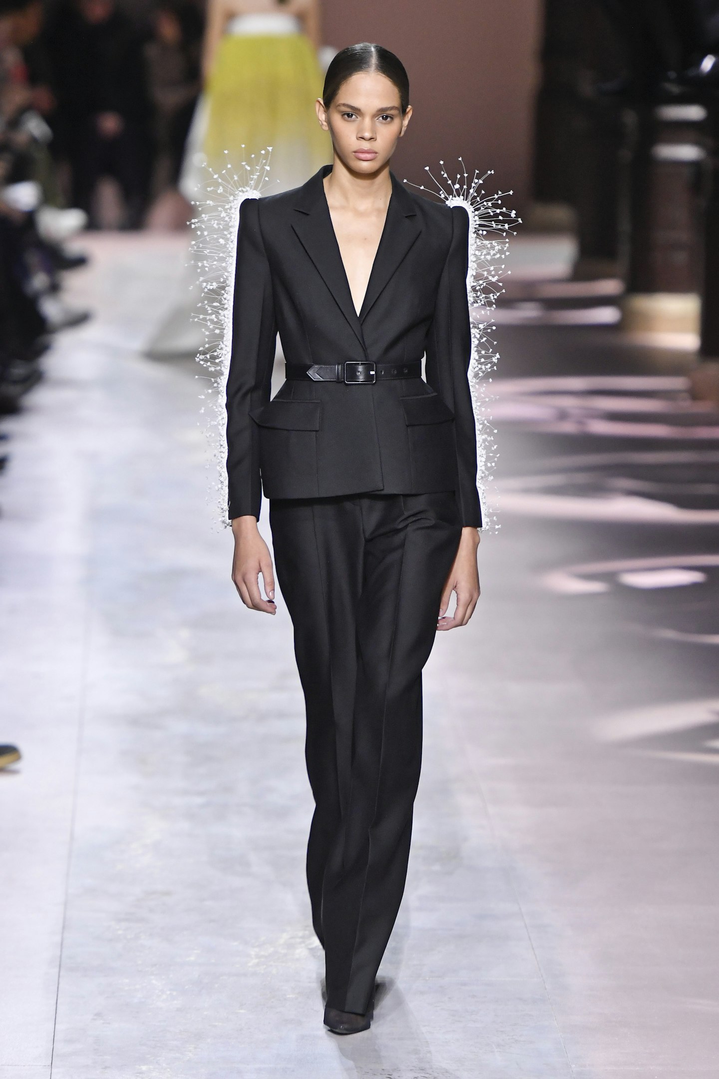 Model in tailored suit walks Givenchy Couture runway