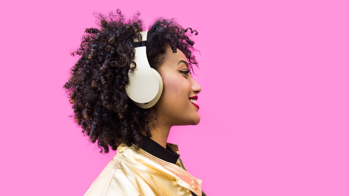 Woman listening to music streaming service on headphones
