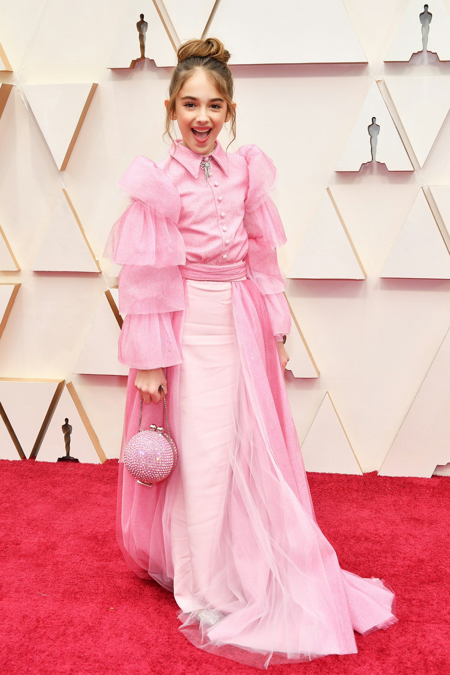 Julia Butters in a pink Christian Siriano ensemble with a Lark & Berry necklace