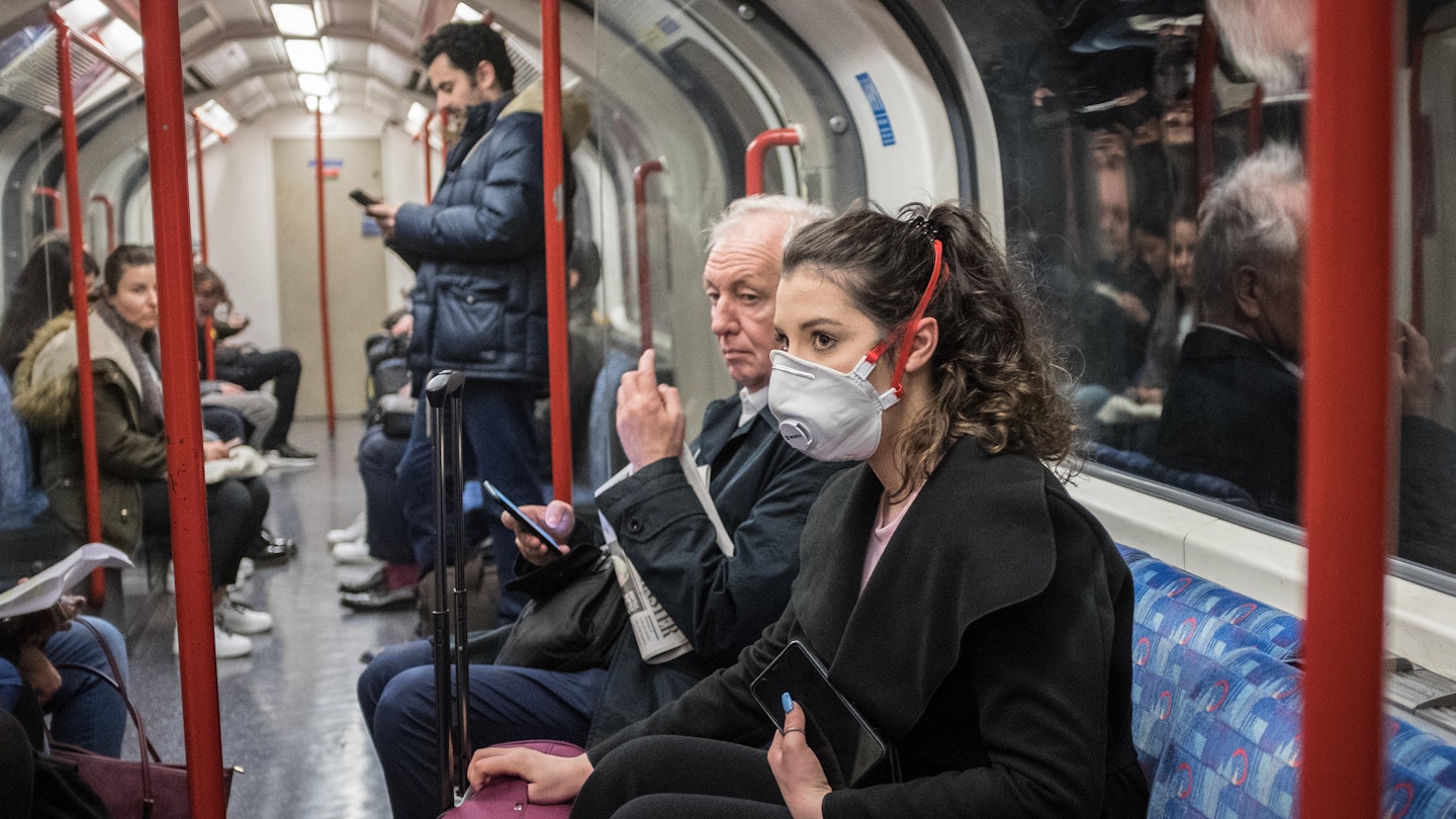Woman on the tube in mask