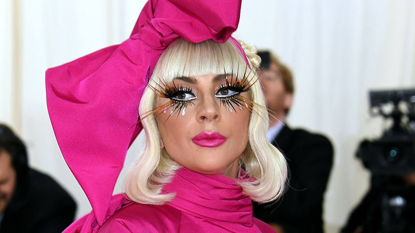 Lady Gaga wearing a pink dress and hat