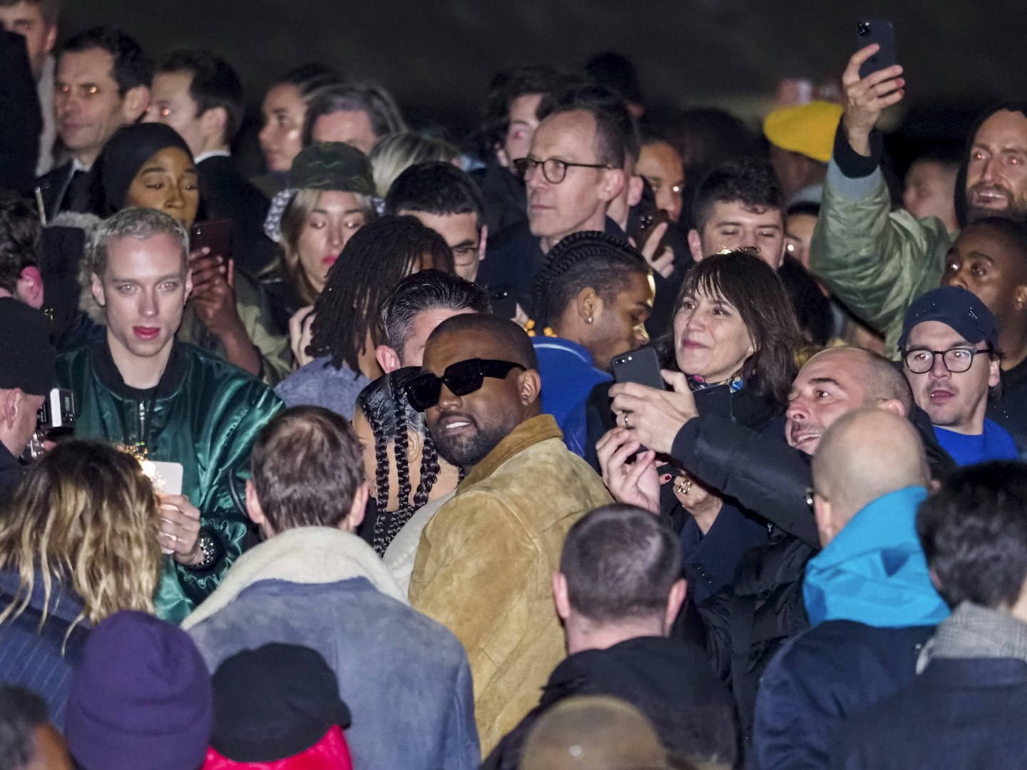 Kanye swarmed by the crowd after his Yeezy fashion show