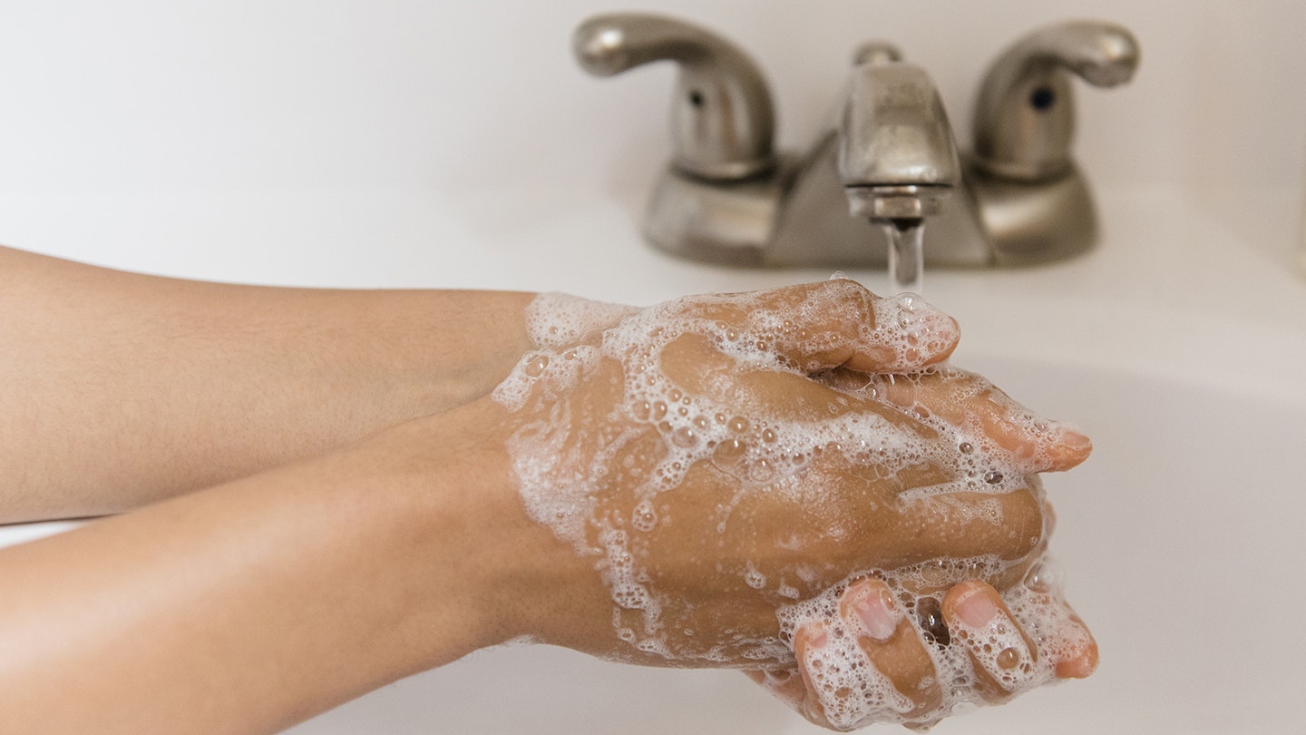 Person washing hands with the best hand wash and soap