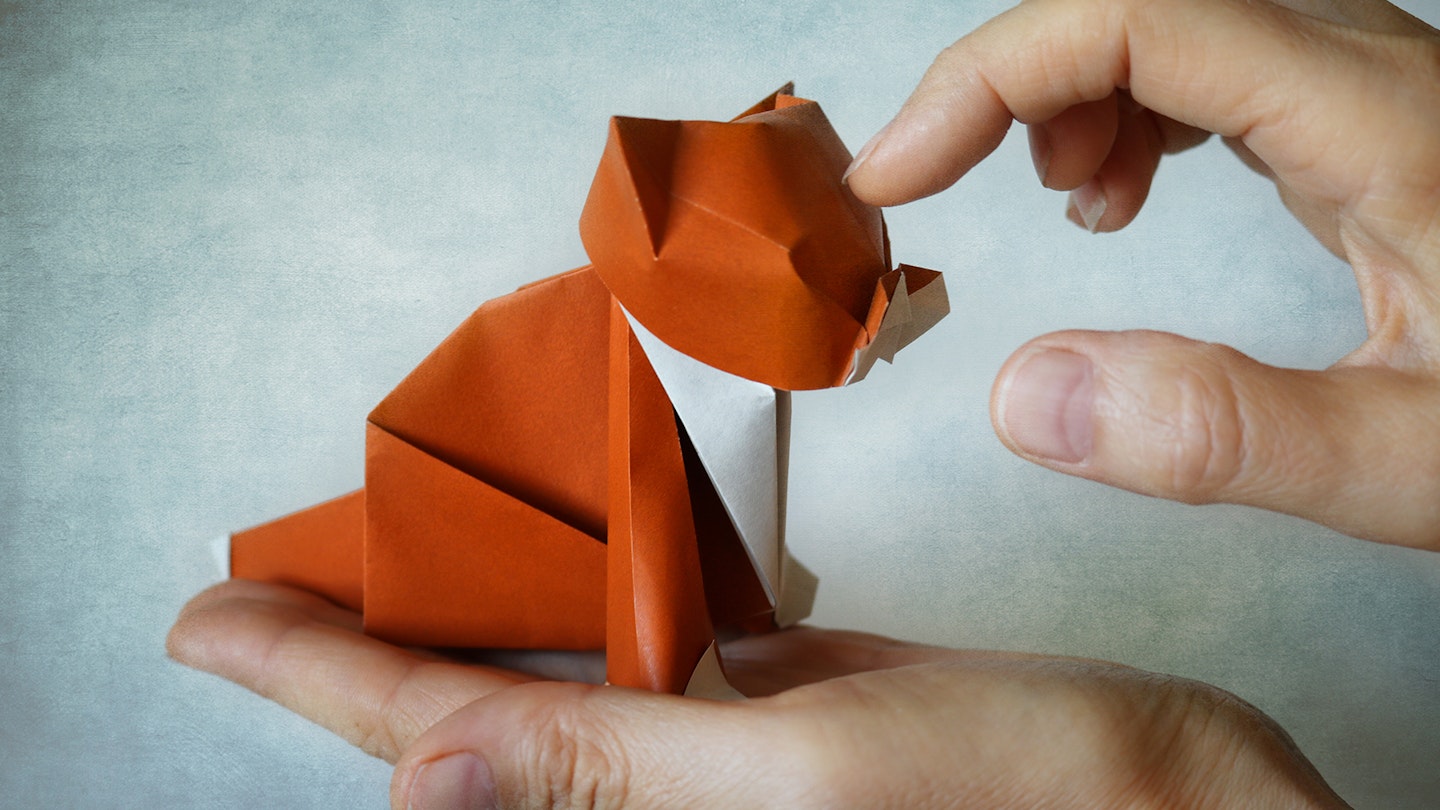 Origami cat on person's hand