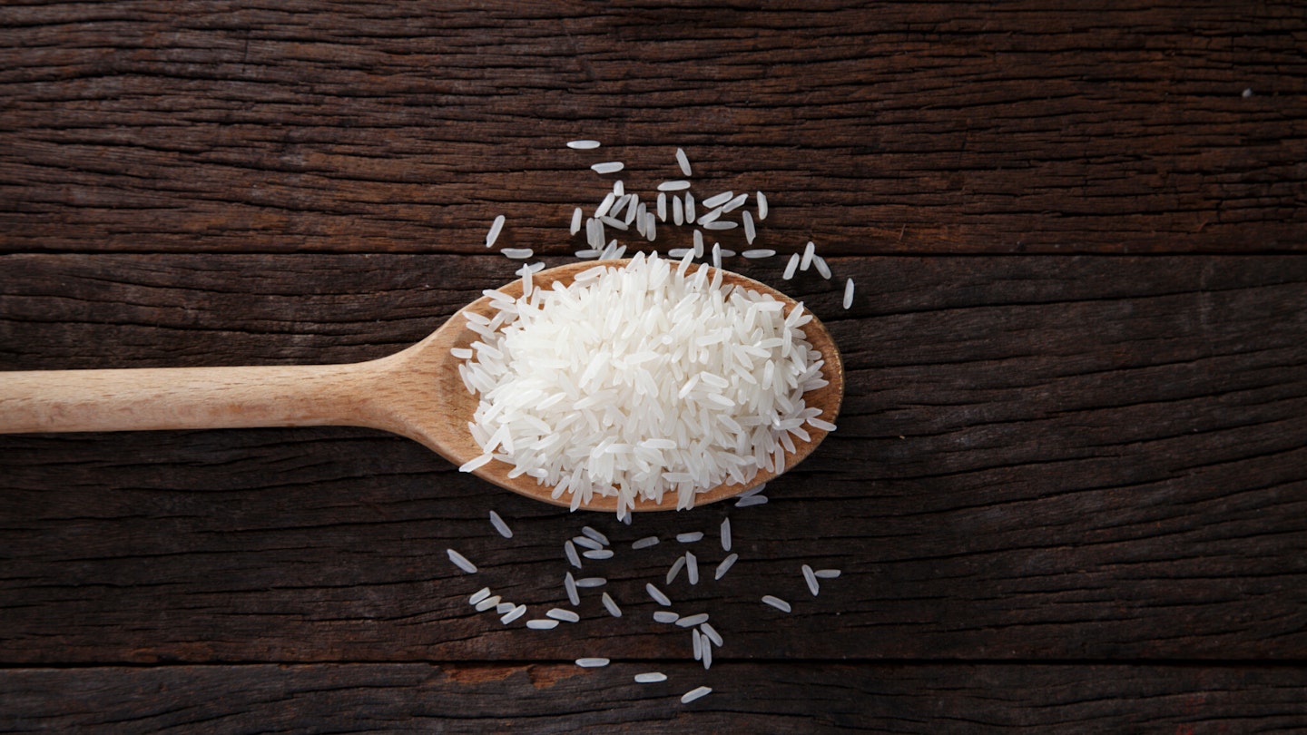 Rice on a wooden spoon - best rice cookers