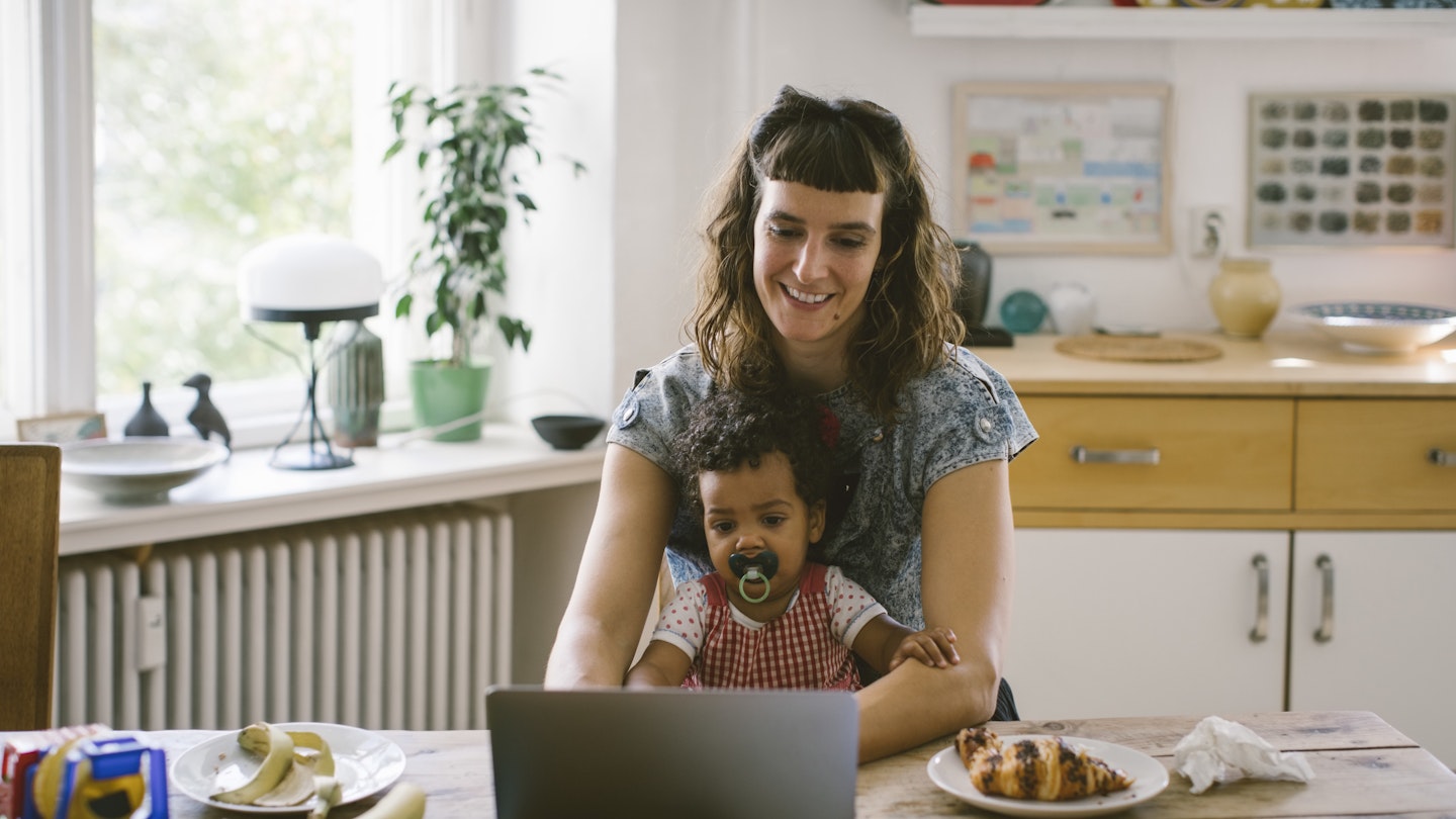 Woman working at home with toddler 