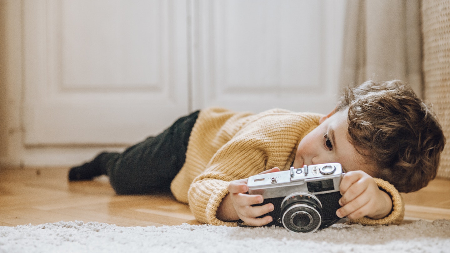 Boy with camera with a Nikon lens