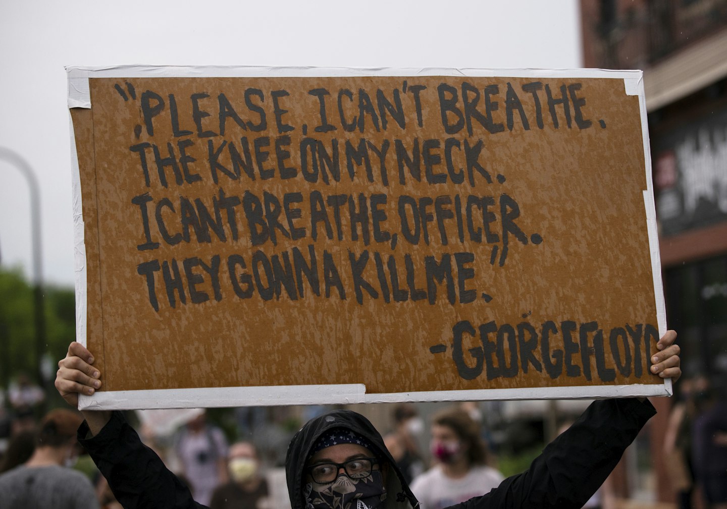 A protester holds a sign while demonstrating against the death of George Floyd outside the 3rd Precinct Police Precinct on May 26, 2020 in Minneapolis, Minnesota