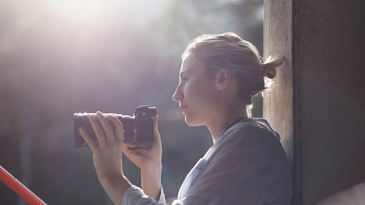 Woman photographer with Olympus lens