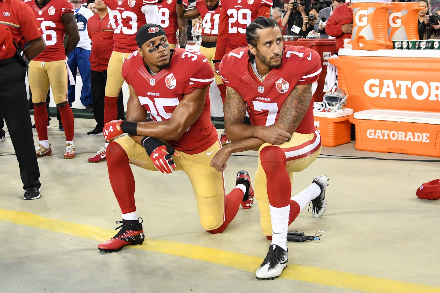 Colin Kaepernick and Eric Reid kneel during national anthem. 