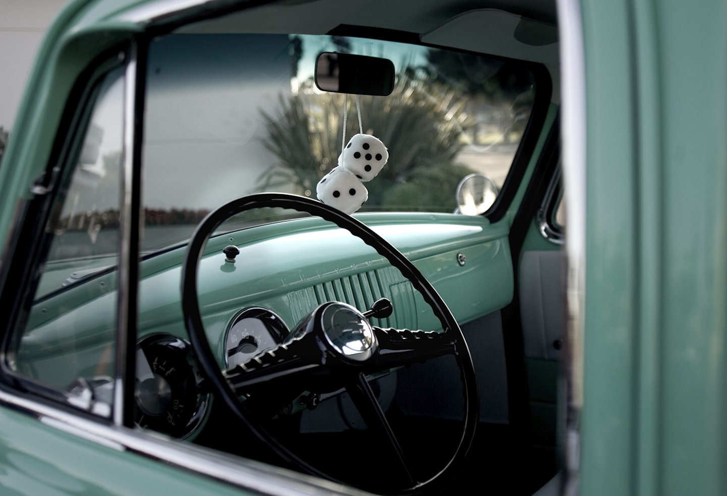Fluffy dice in an old car