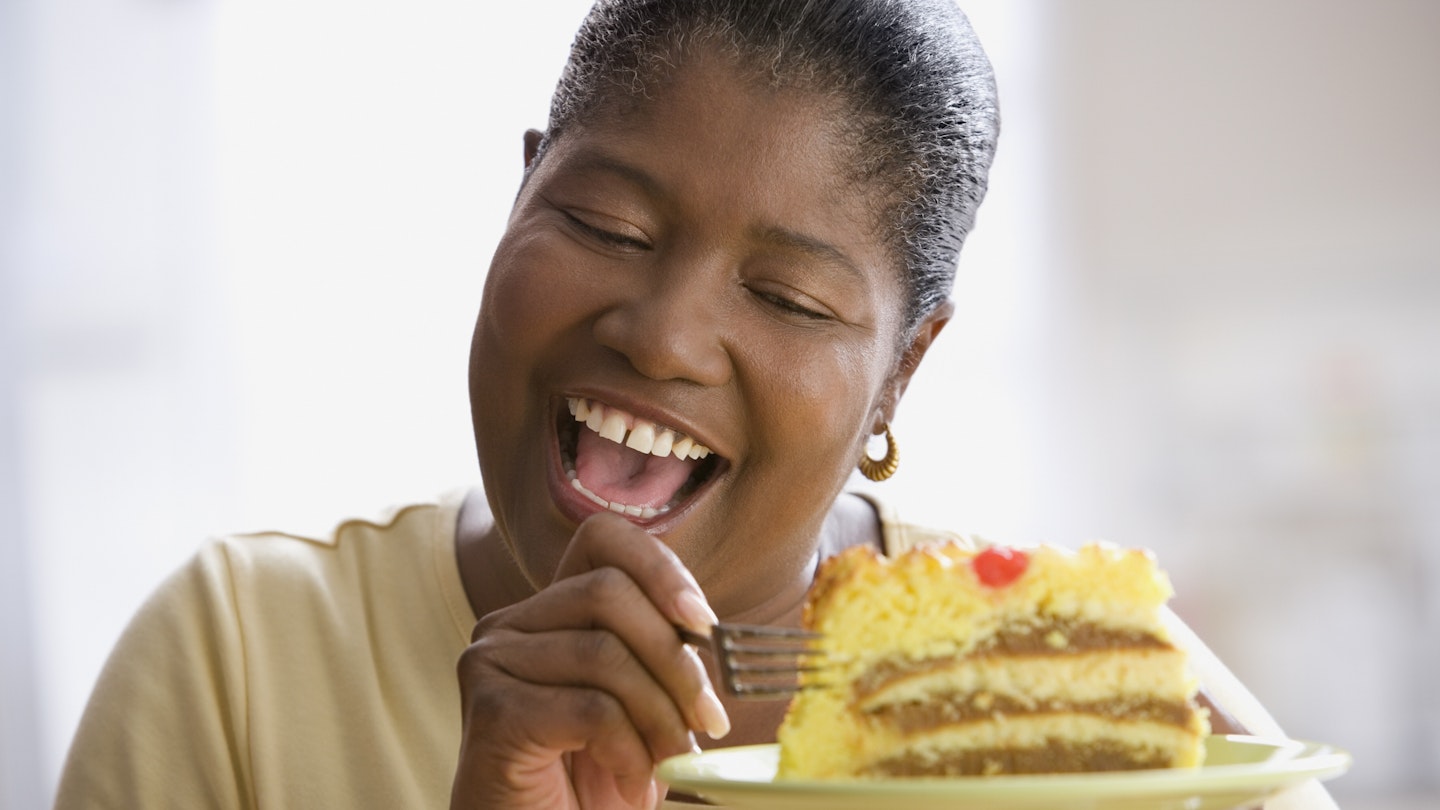 Mature woman eating cake 