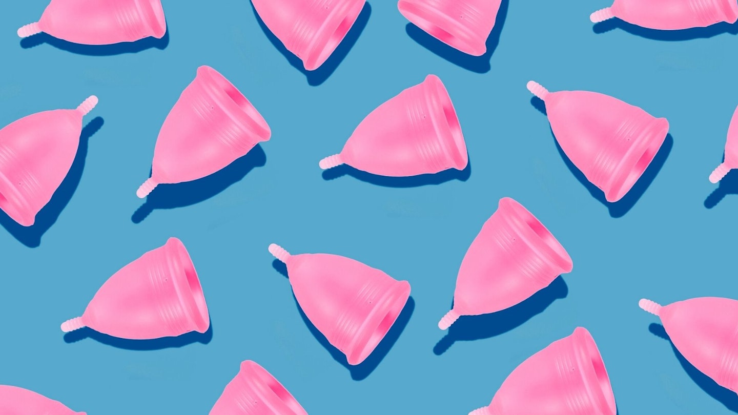 Eco-friendly and reusable pink menstrual cup pattern on blue background