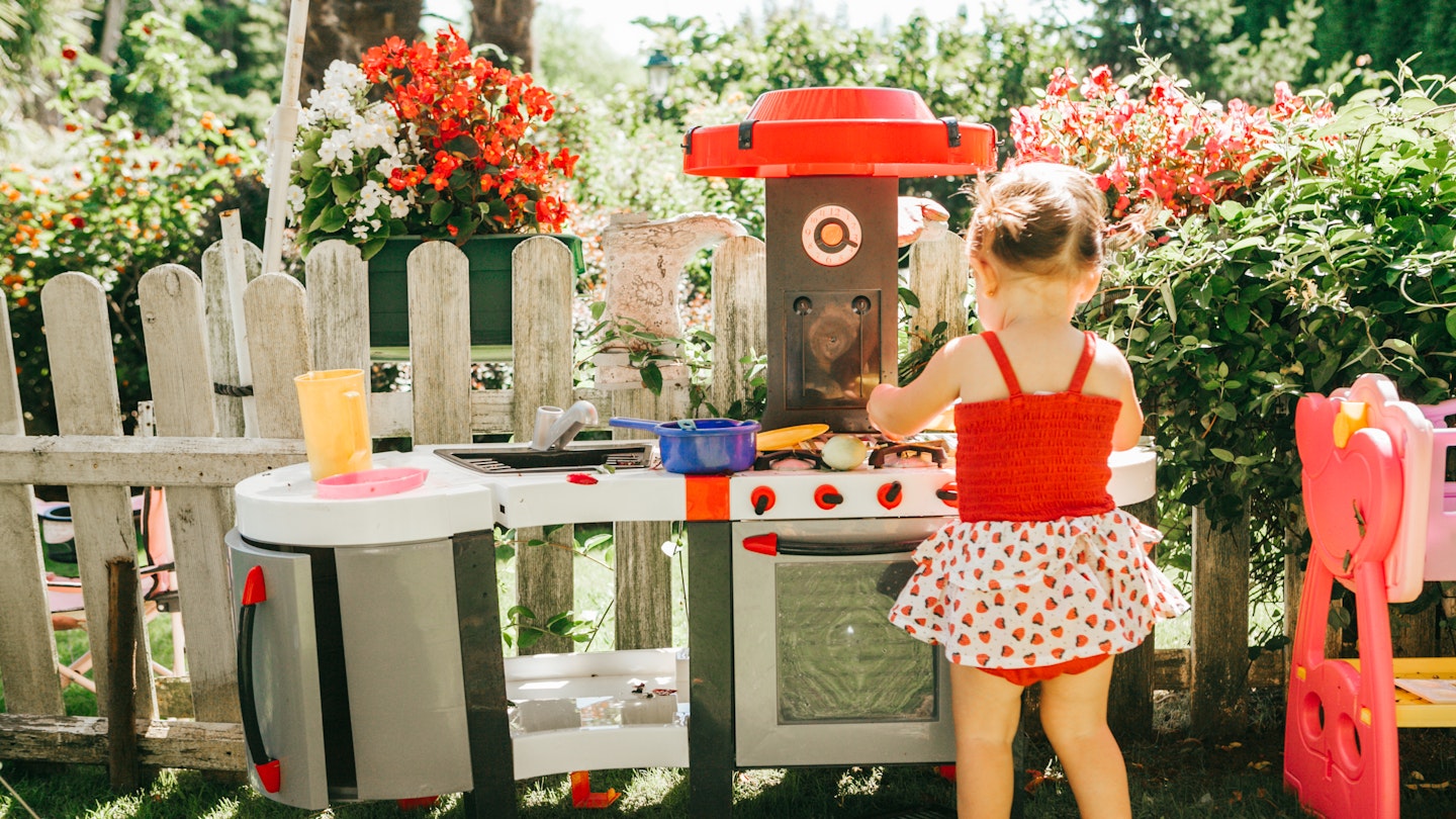 Child playing with toy oven