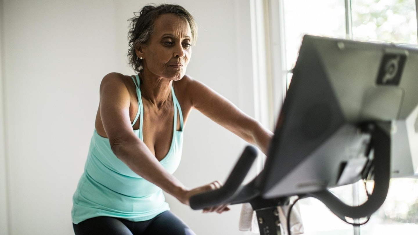 the best exercise bike - mature woman on exercise bike
