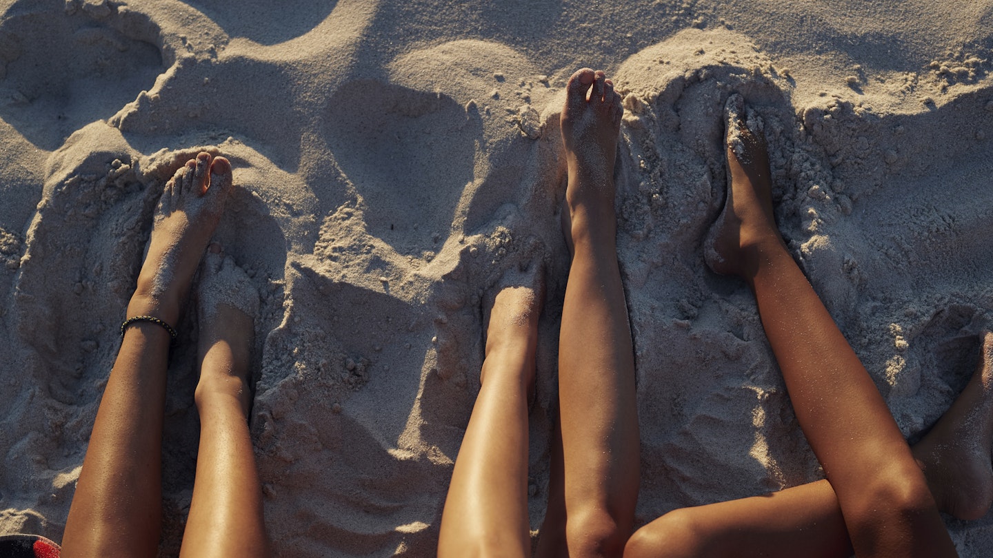 Legs In The Sand On The Beach