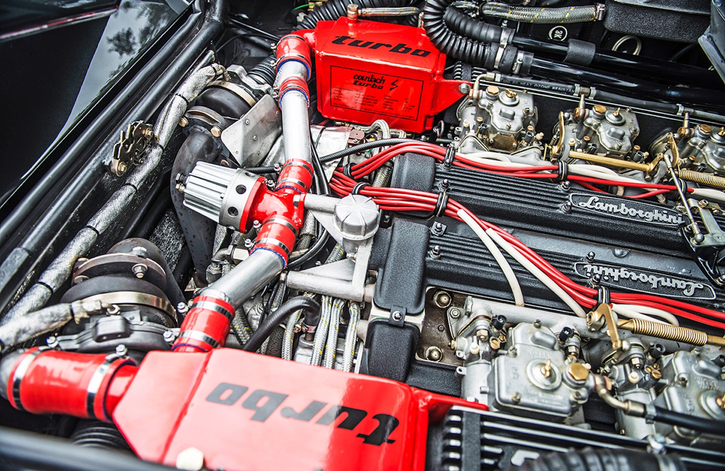 A peek into the engine bay leaves no doubt as to this 4754cc V12’s aspiration
