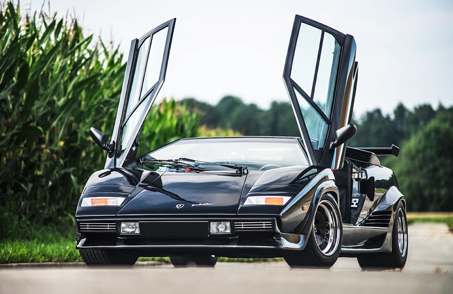 By now I’ve turned the ignition key halfway and the fuel and oil pumps are moaning and ticking, preparing to wake up the big quad-cam V12. By the time this car was produced, the LP400’s 3929cc motor had been bored and stroked out to 4754cc. It still produced 375bhp, but now peak power came at 7000rpm – 1000rpm lower than its predecessor. Torque was higher – 302lb ft, up from 268lb ft at a very accessible 4500rpm. Ironically, Giulio Alfieri, Lamborghini’s technical director since 1978, had dismissed turbocharging as a power option, saying it was ‘only really useful at the top end, while sacrificing the bottom end’. A quick twist of the key and the engine fires, a starter motor’s whinny followed by a hacking guttural cough and spitting explosions. Cranking up, the Countach V12 sounds like an old Chevy V8 kicked into life after a year slumbering in a barn. A hollow metallic moan rises and falls, although jabbing a Countach’s accelerator isn’t something that can be done delicately. The pedal has more weight behind it than many a hatchback’s clutch. But its resistance and travel are smooth and even. The clutch, too, is quite heavy, though nowhere near as recalcitrant as many have claimed.