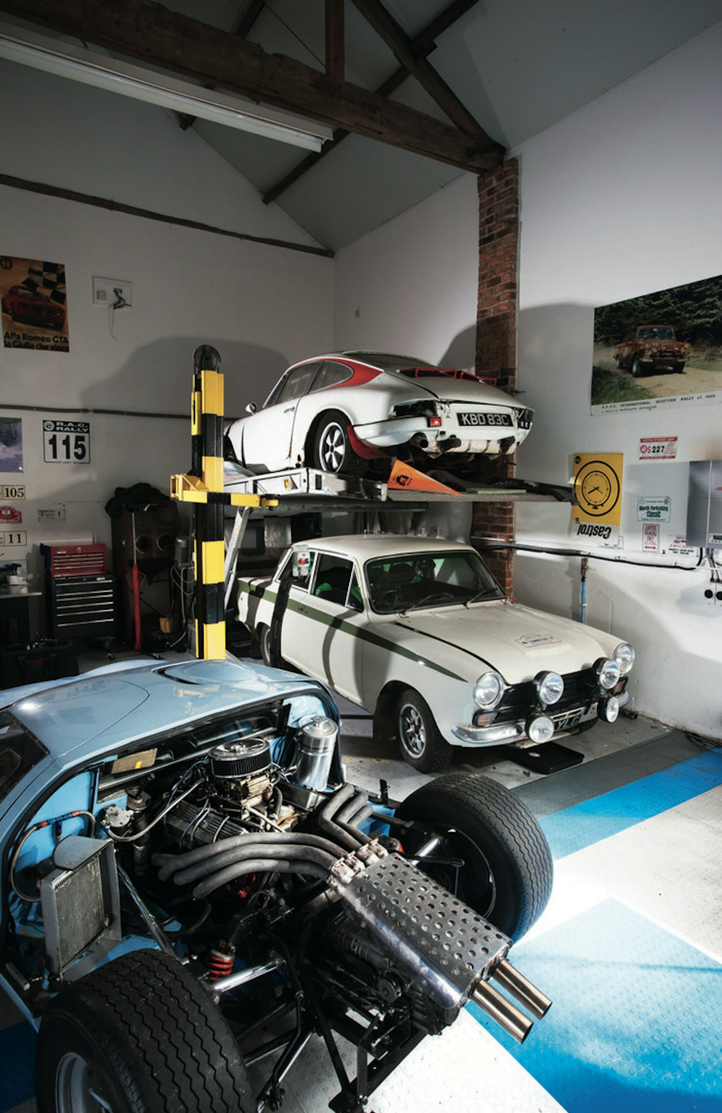 ‘Resting’ Porsche 911 and Lotus Cortina rally cars watch over a GT40 replica