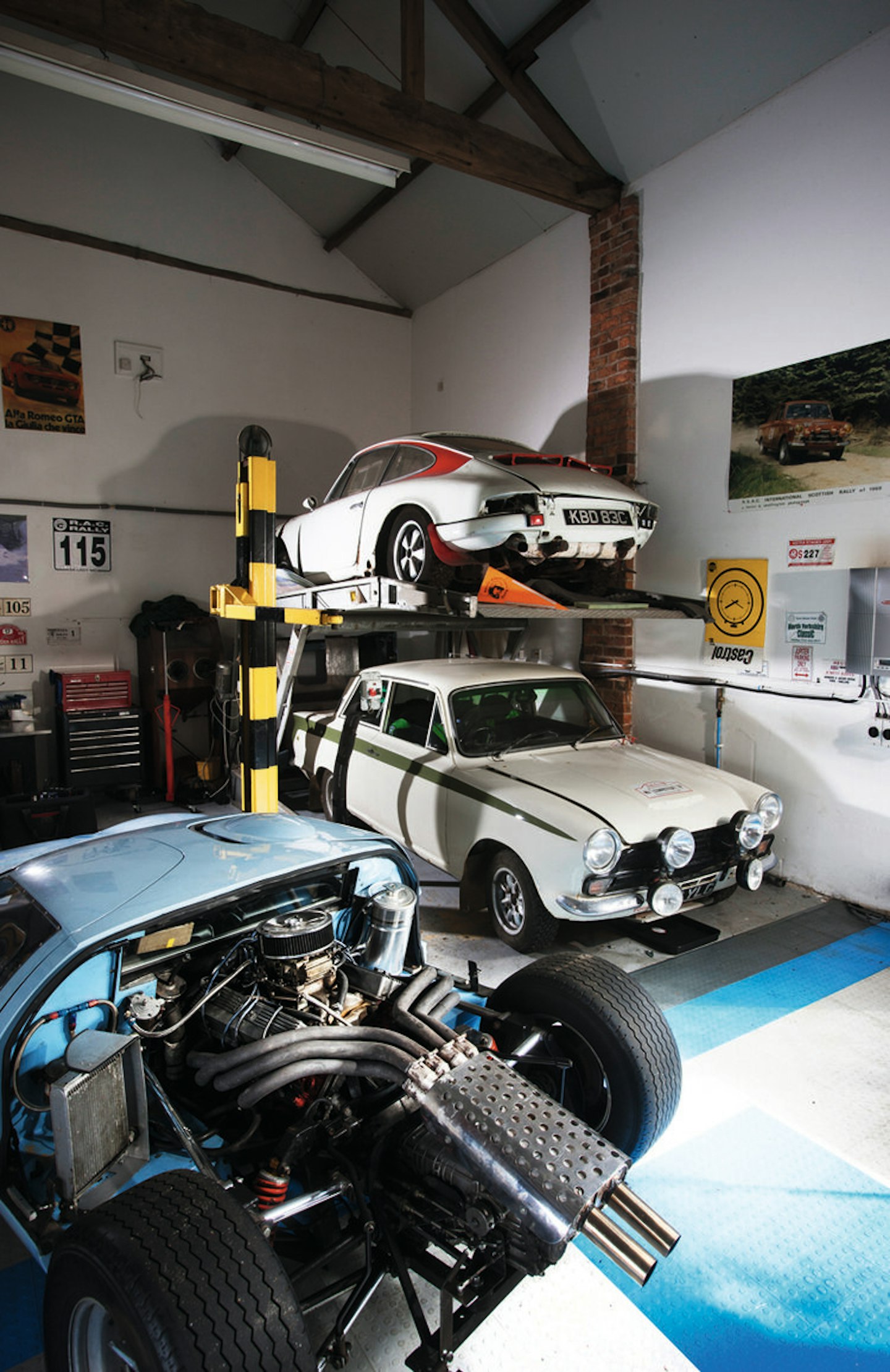 ‘Resting’ Porsche 911 and Lotus Cortina rally cars watch over a GT40 replica