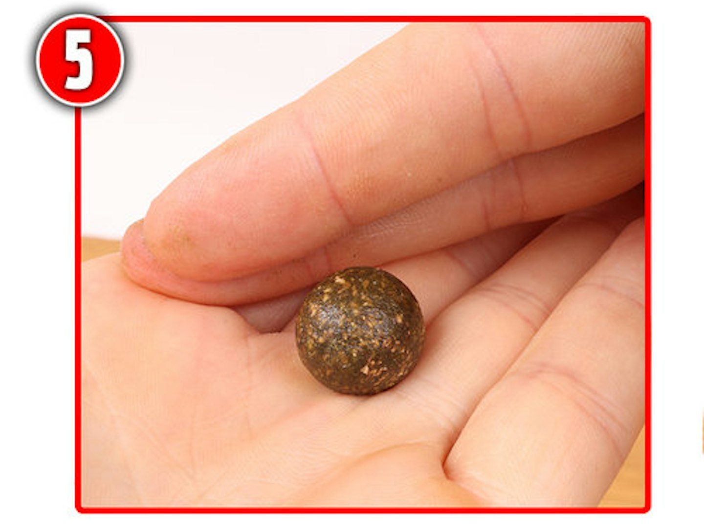 Pinch off a small nugget of bait and roll it between your palms until a round ball is produced.  