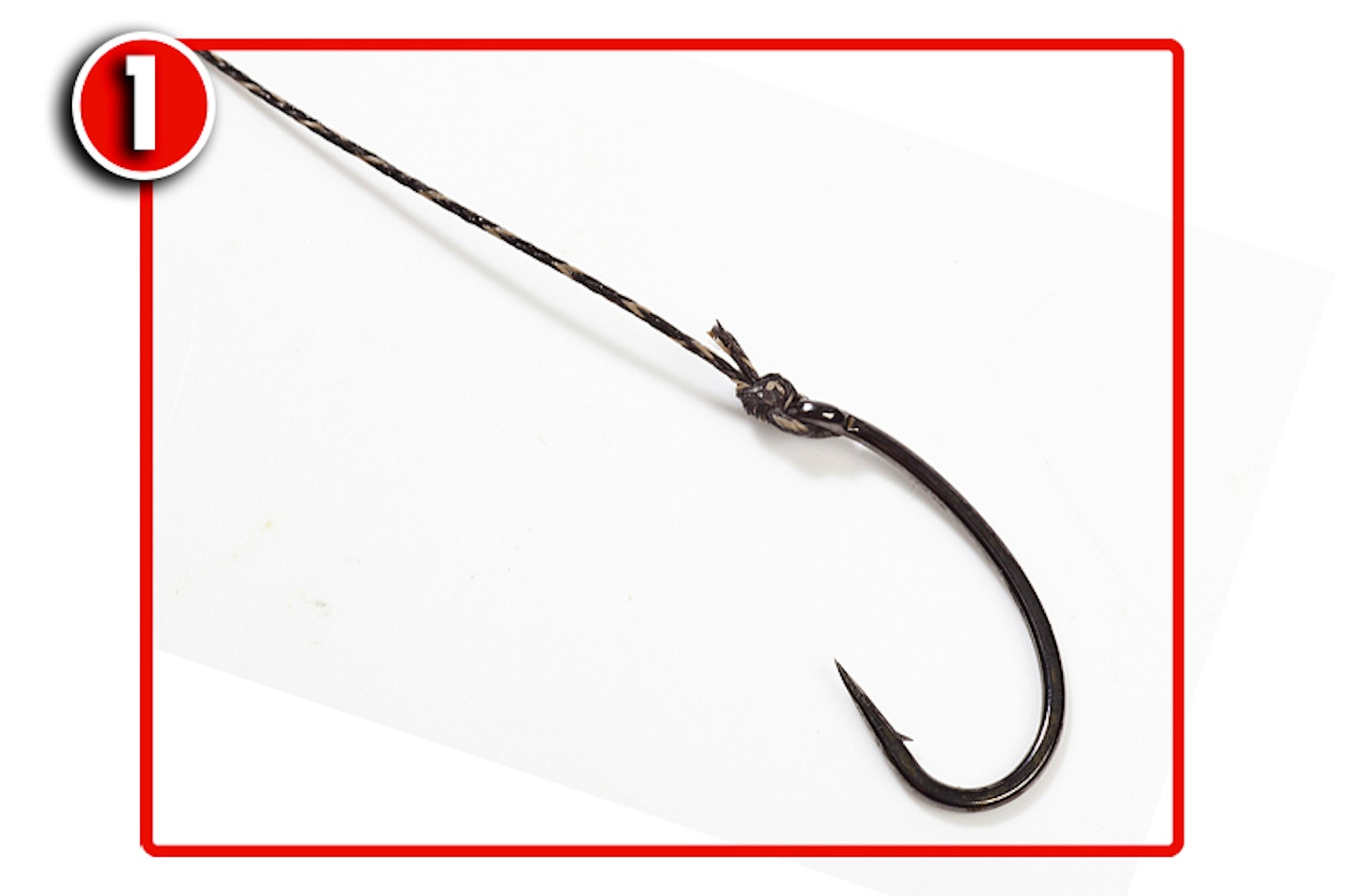 Tie on a curved shank hook. We’ve used a palomar knot here, but a grinner is also fine to use.