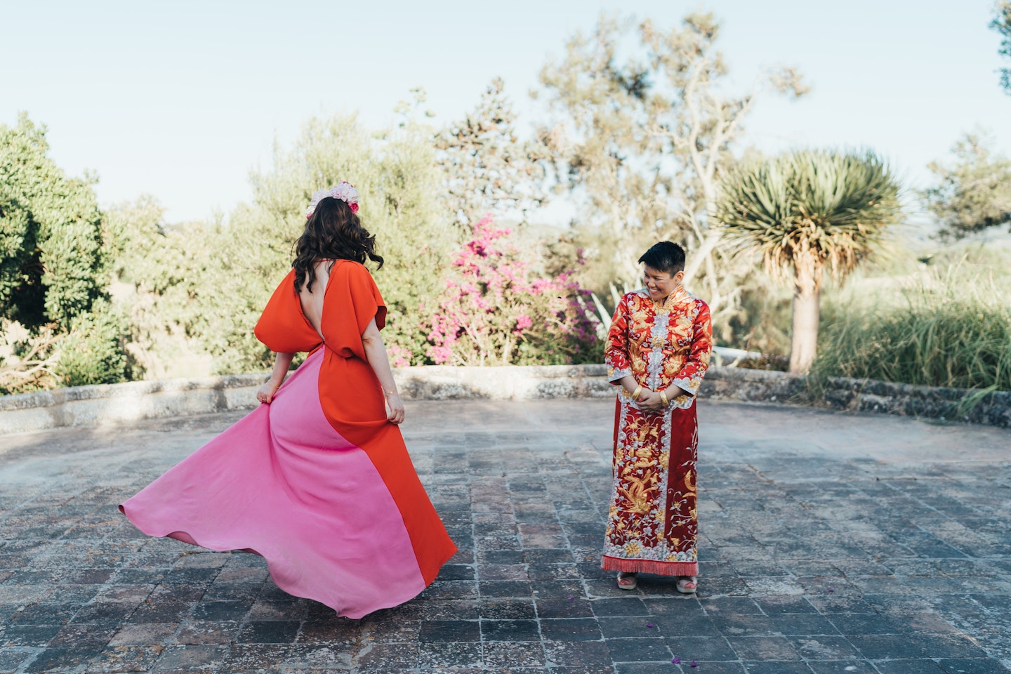 Alice (L) and her wife (R) in their wedding outfits