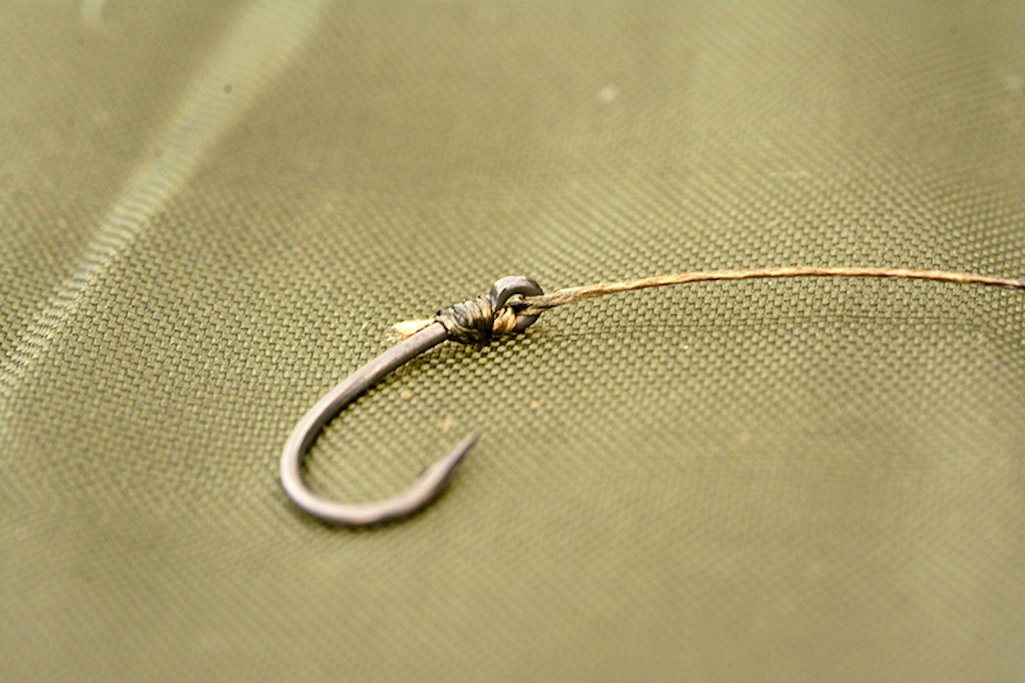 Take a short length of supple braid and attach to a curved shank hook using a knotless knot 