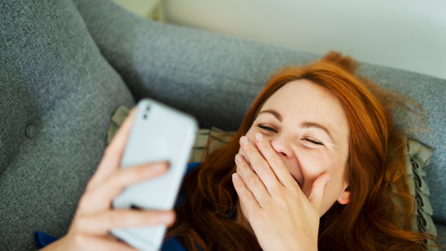 Woman laughing at home