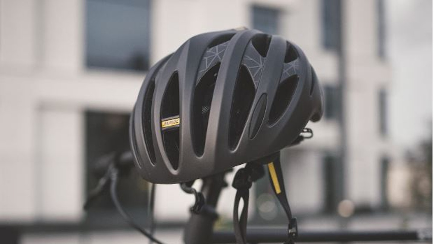 The best road cycle helmets: black helmet resting on handlebars