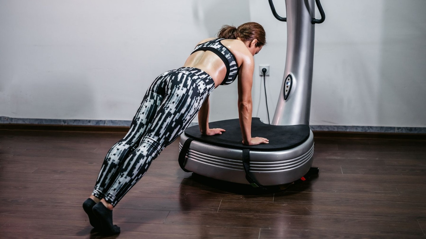 Woman working out on a vibration plate