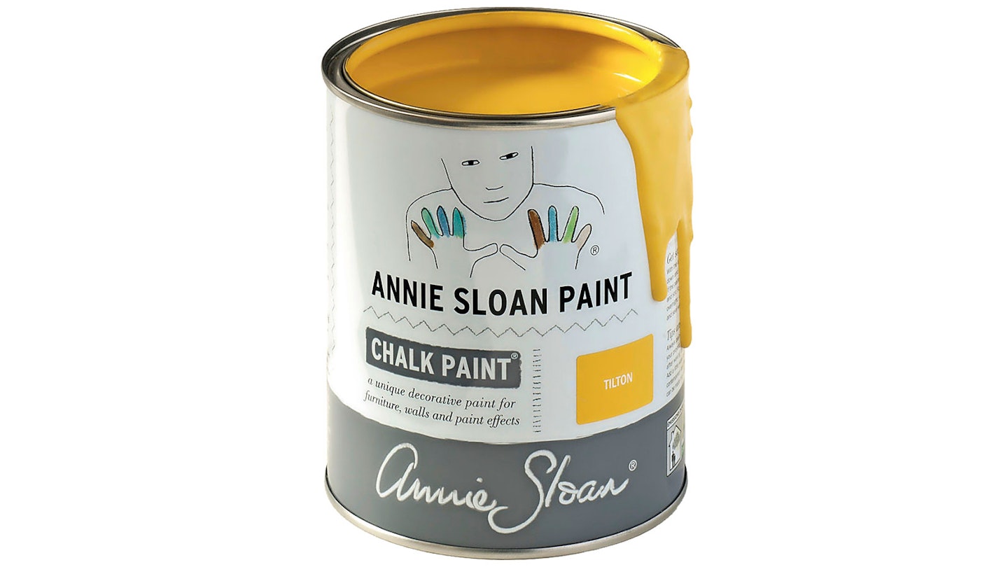 paint tin with yellow paint dripping over edge