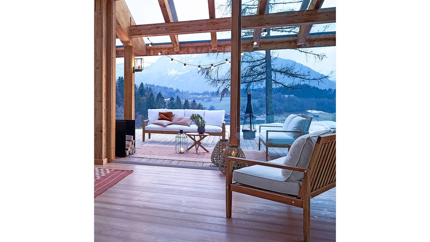 wooden lodge looking out over mountains with wooden decking