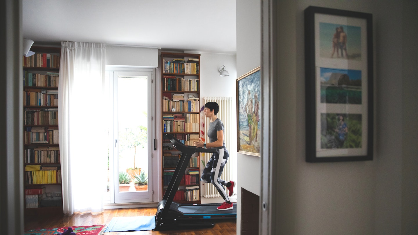 Woman uses treadmill at home