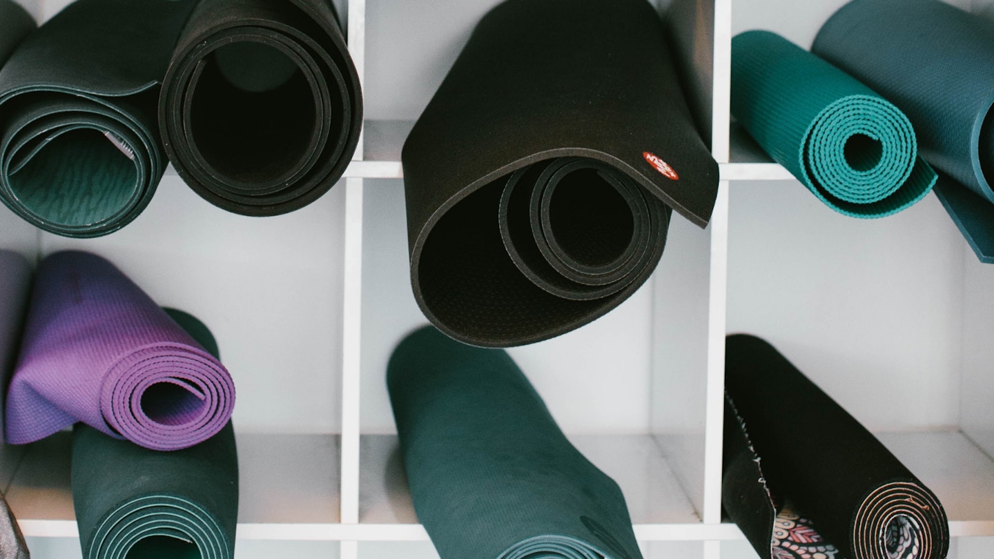 The best exercise mats stacked on a shelf