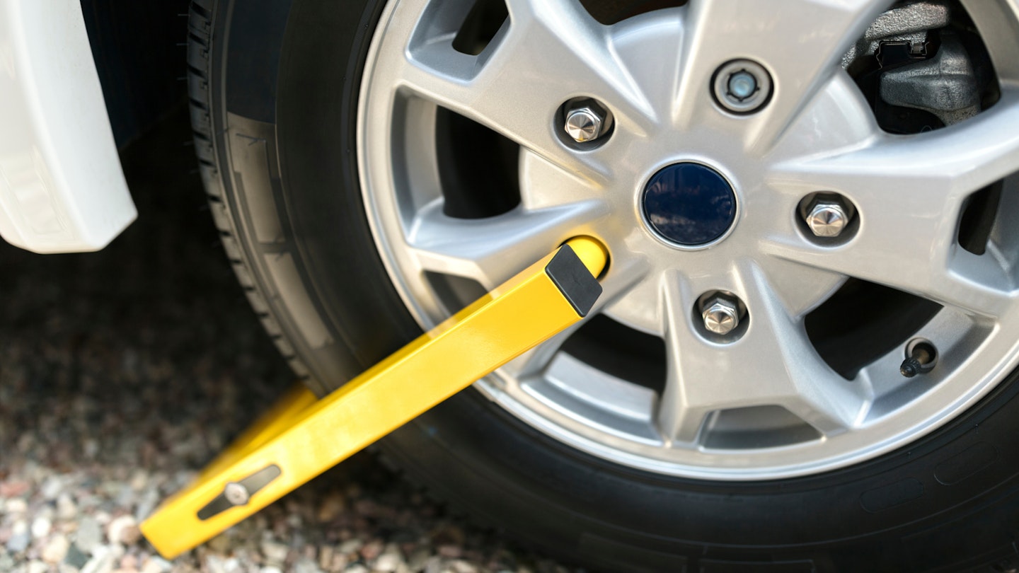 A wheel clamp attached to a car