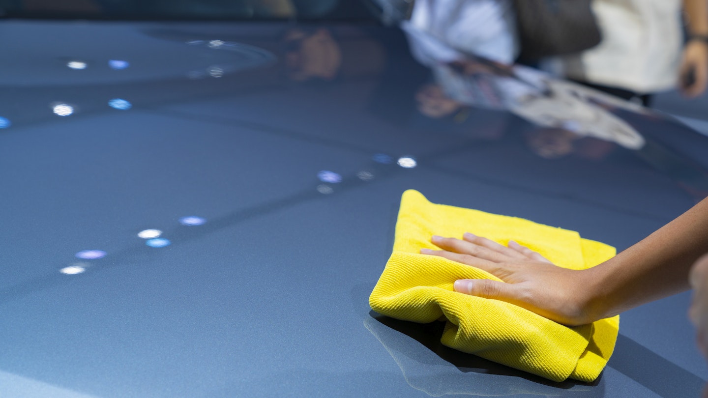 A microfibre cloth being used on a car bonnet