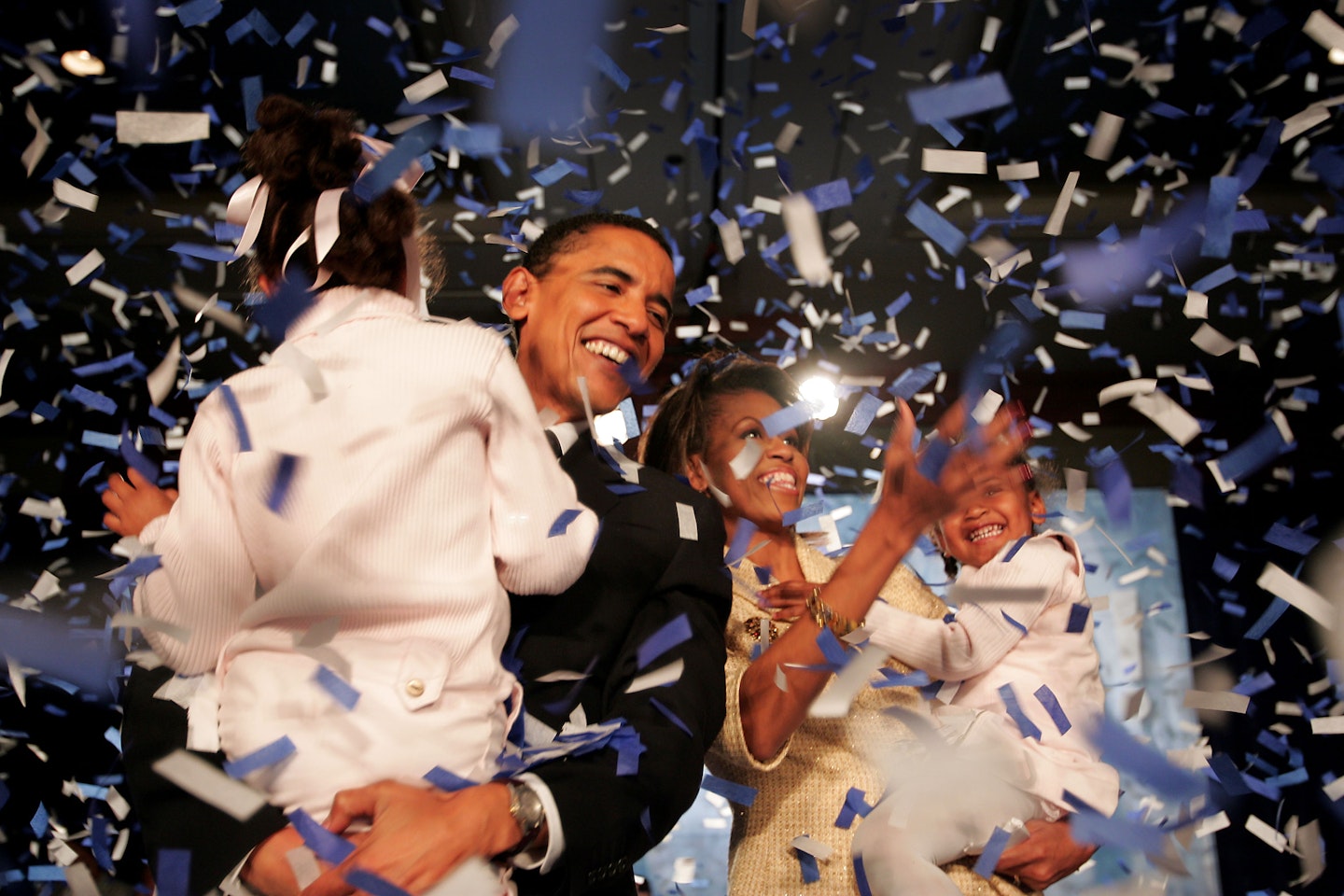 Senate Barack Obama (D-IL) and his daughter Malia (L), wife Michelle and youngest daughter Sasha (R) celebrate his victory with supporters over Repulican rival Alan Keyes November 2, 2004 in Chicago, Illinois.