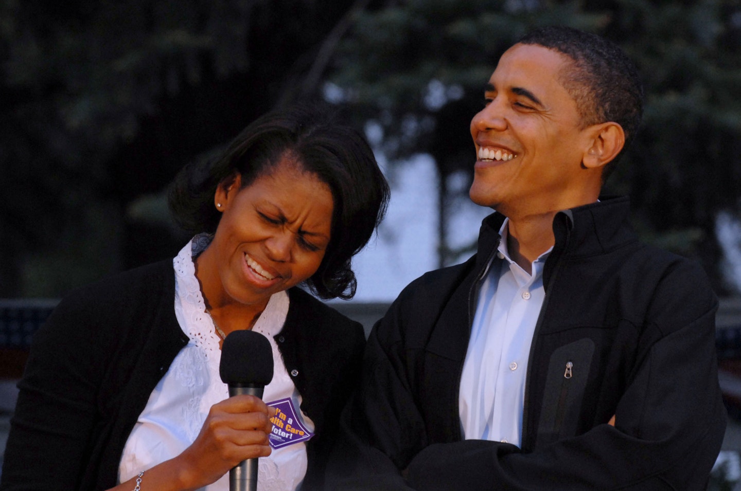 Barack Obama and his wife Michelle laugh together at an "ice cream social" campaign event at Veterans Memorial Park in Berlin, New Hampshire, on Sunday, May 27, 2007.