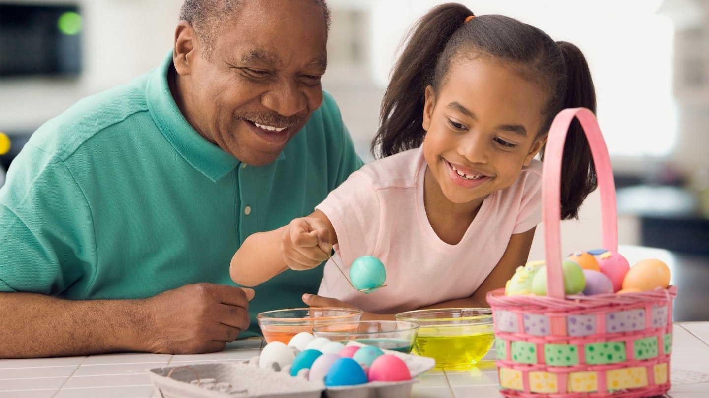Make your own Easter egg: African Grandfather and granddaughter colouring Easter eggs