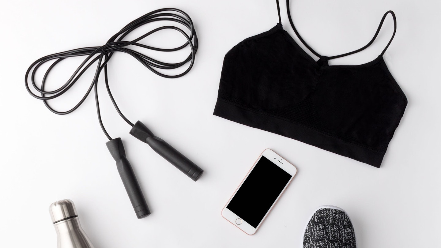 A grey skipping rope and other high-end fitness gear against a white backdrop
