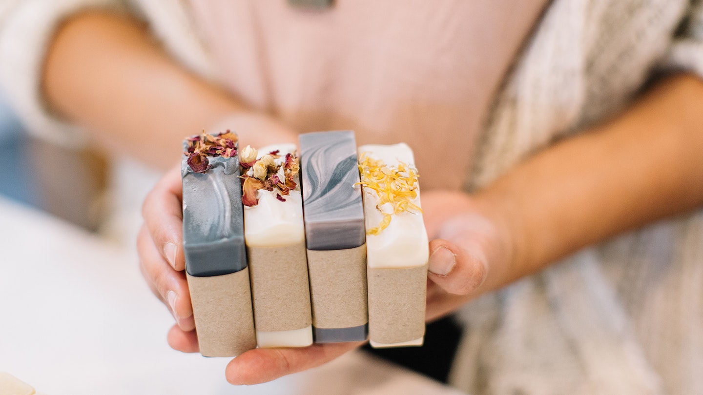 Woman holding eco-friendly soaps