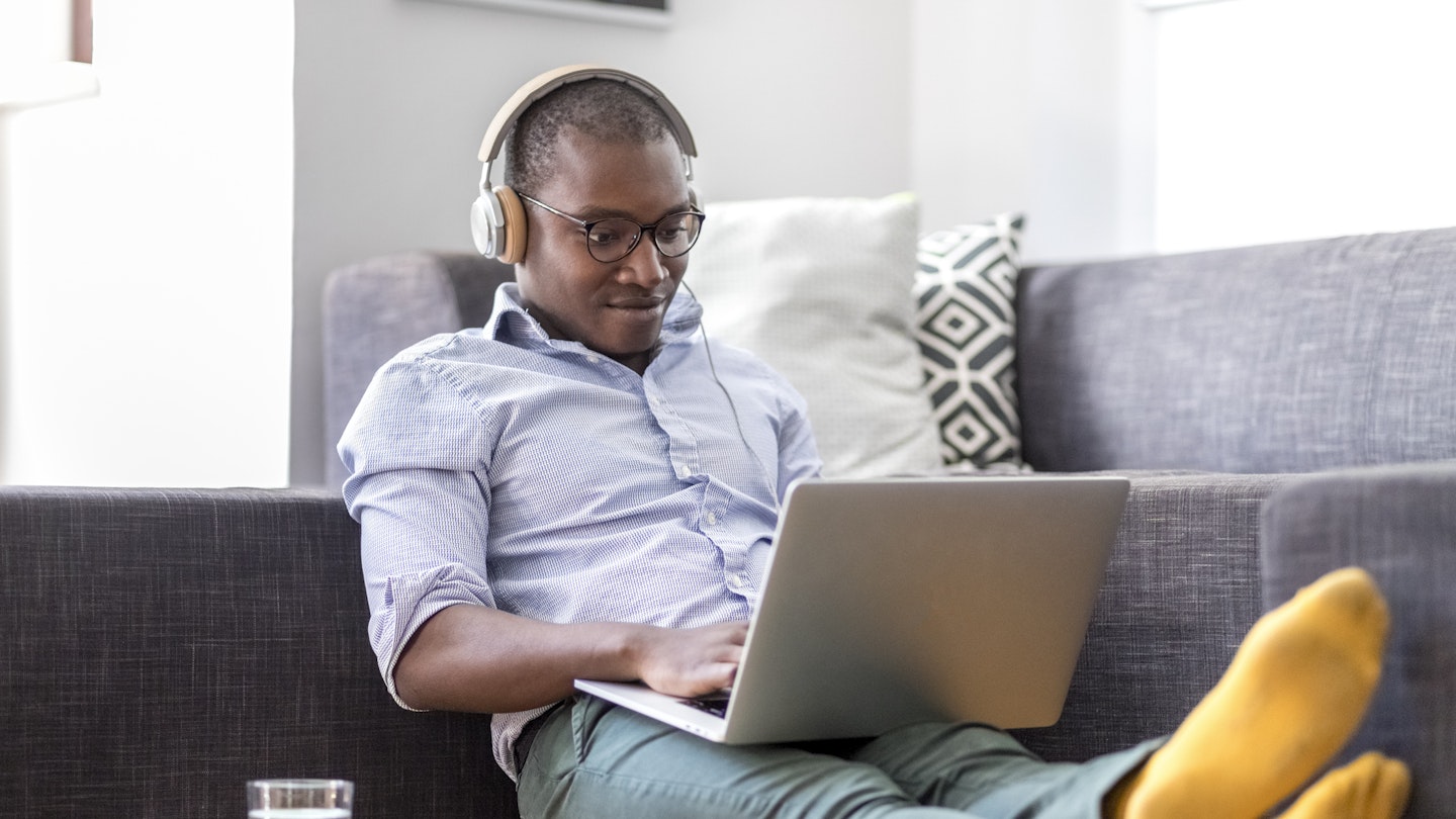 A man listening to music on his laptop 
