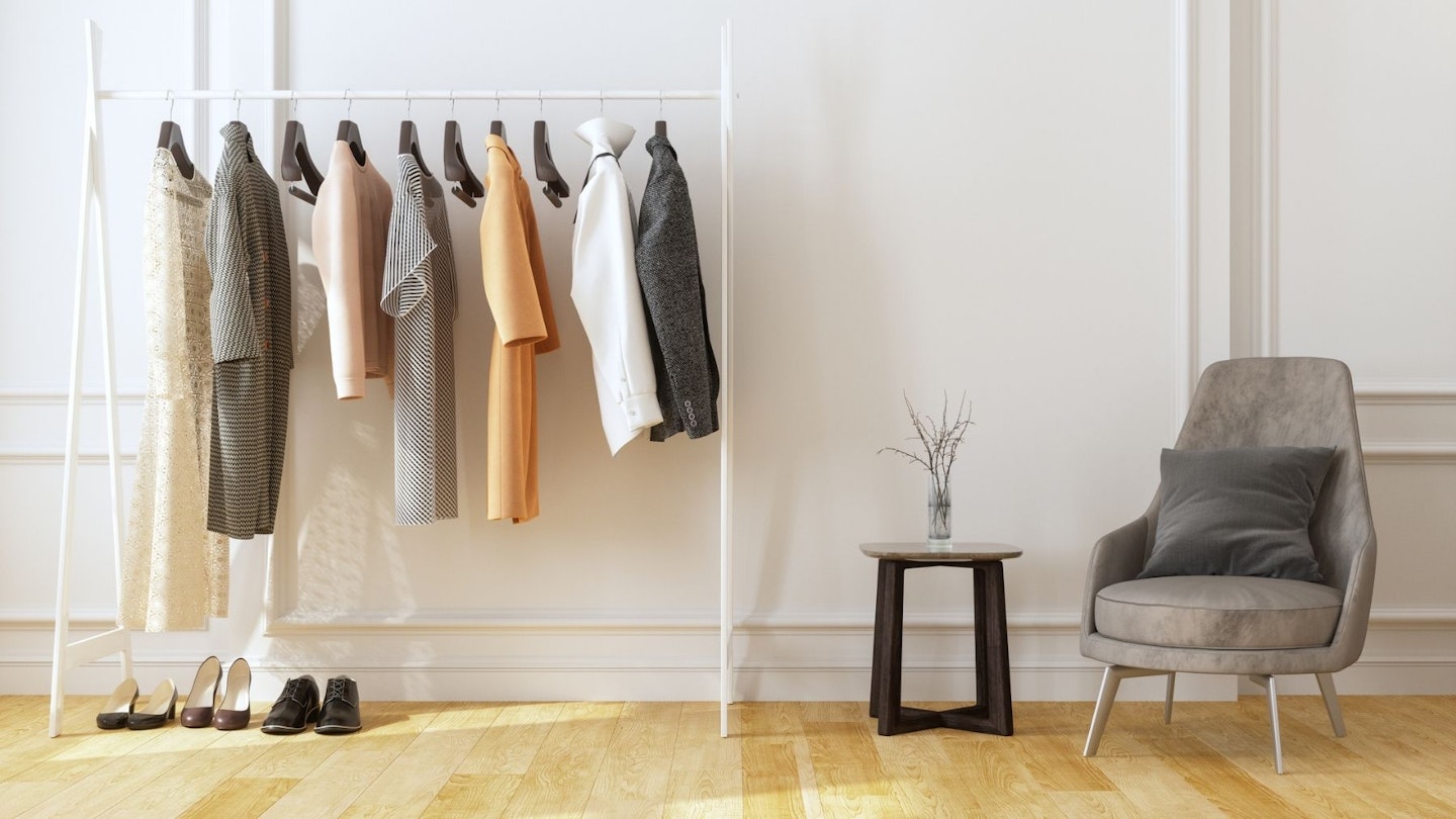 Best clothes rails: Armchair And Hanging Clothes In The Dressing Room