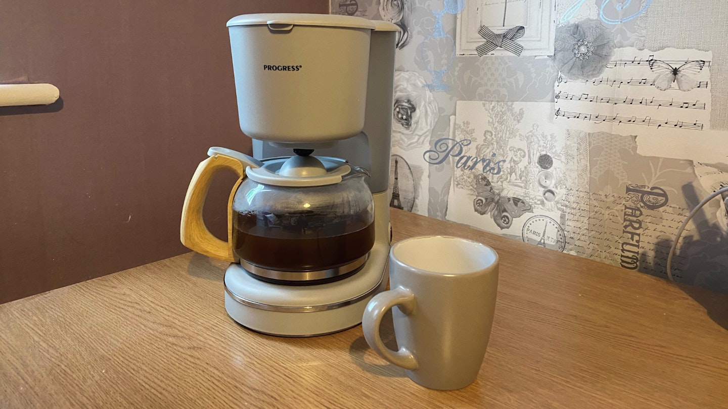 Progress Scandi Coffee Maker in grey with a coffee mug